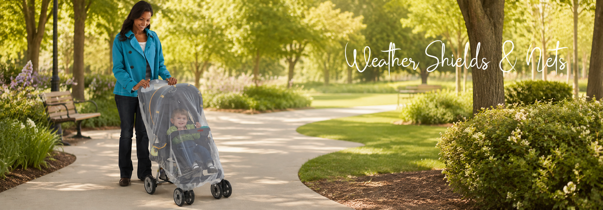 Mom pushing baby stroller with weather shield in park, protecting infant from elements during outdoor walk