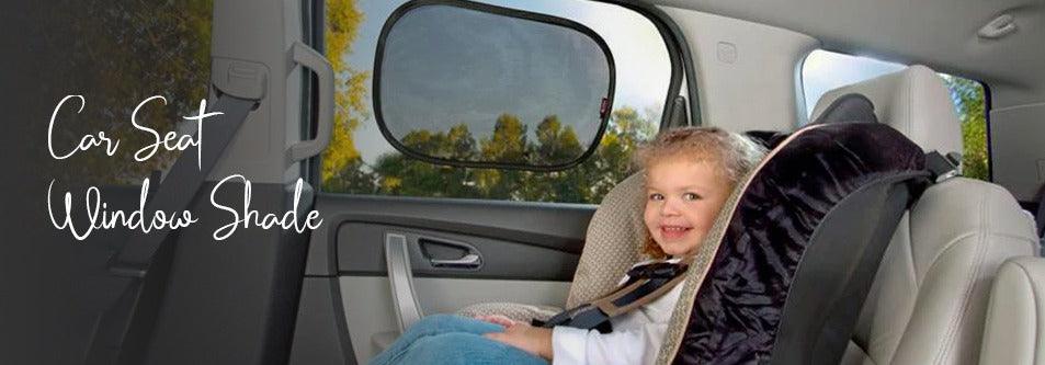 Baby in car seat with window shade, smiling during ride