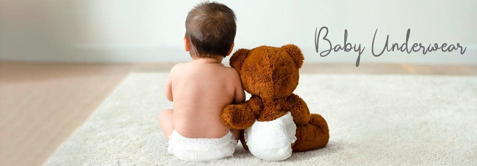 Baby in diaper sitting with teddy bear, baby underwear
