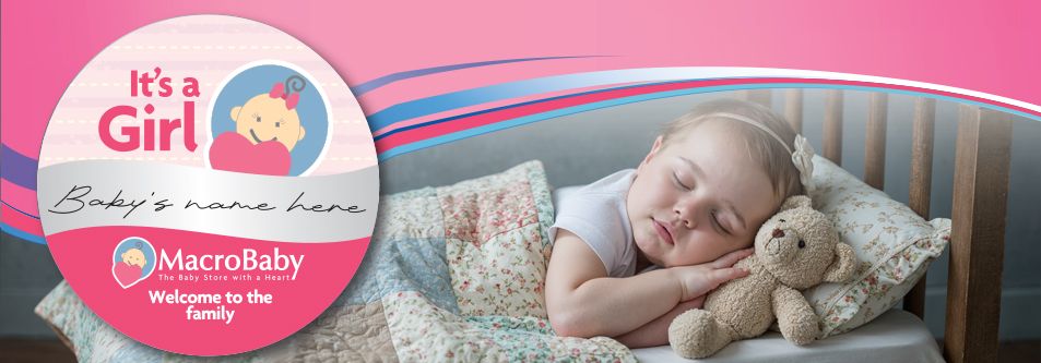 Baby girl sleeping peacefully in crib with teddy bear, floral bedding, and 'It's a Girl' welcome sign