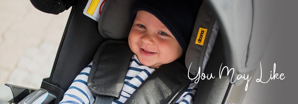 Happy baby in striped outfit smiling in a Donor car seat, perfect for safe travel and comfort.
