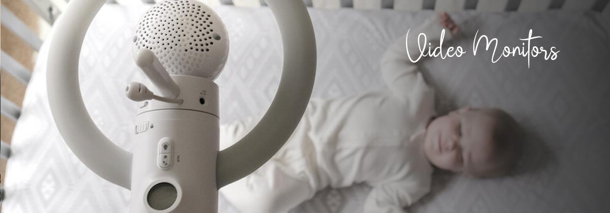 Baby video monitor with nursery camera watching infant in crib, safe sleep monitoring