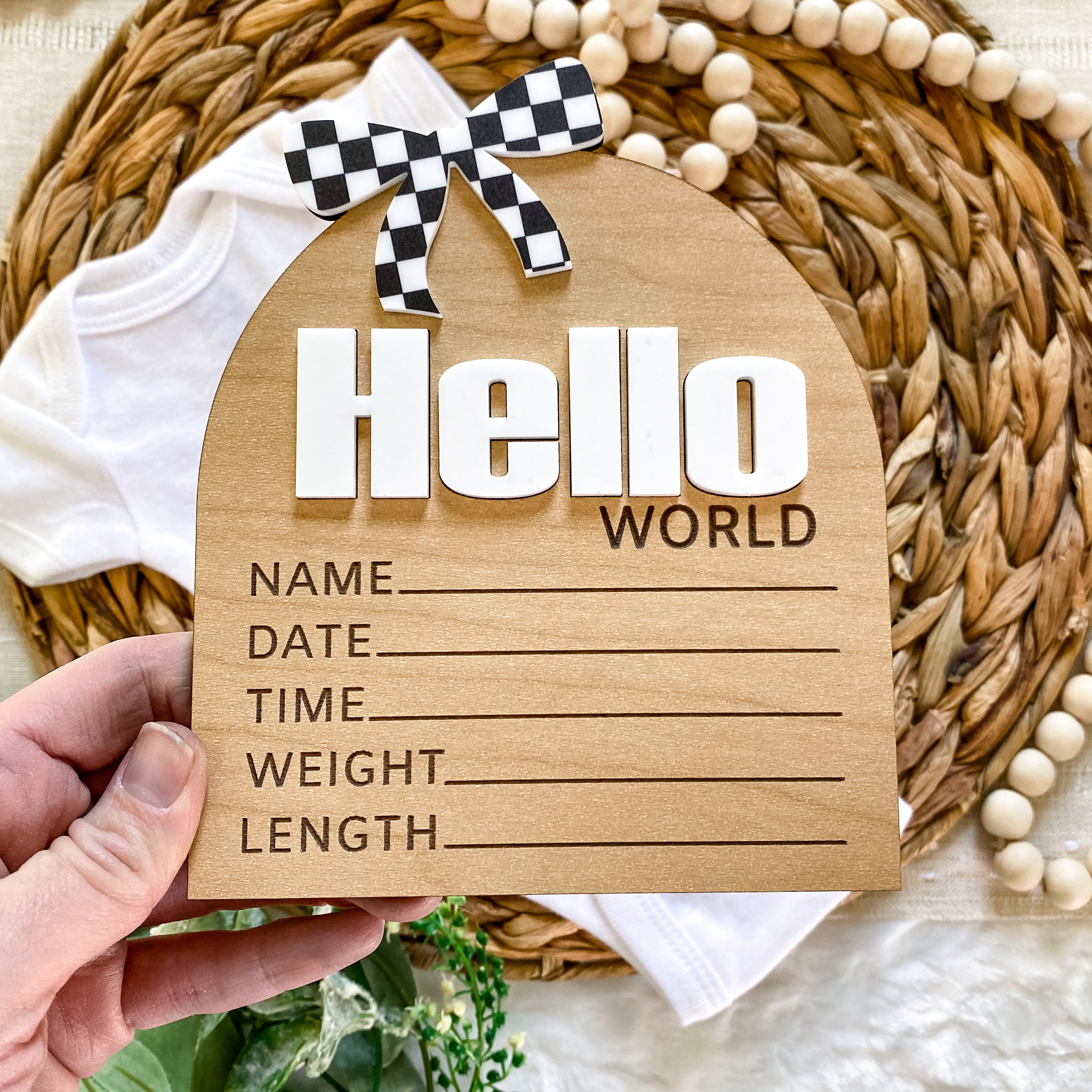 Hello World baby announcement sign with checkered bow, perfect for newborn photos and baby registry