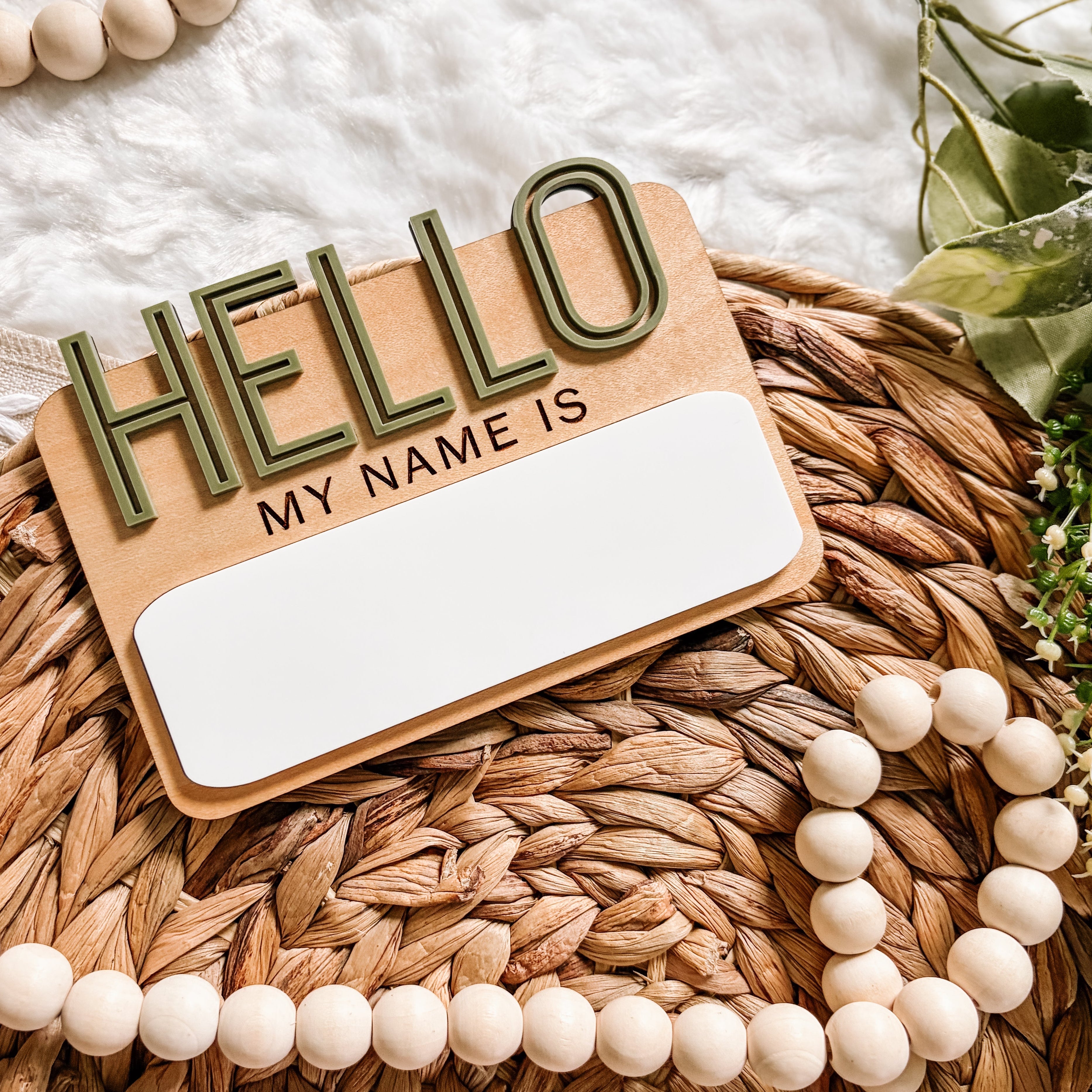 Hello My Name Is sign with wooden beads on woven mat
