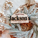 Jackson's First Christmas 2024 wooden ornament with frosted greenery and beads