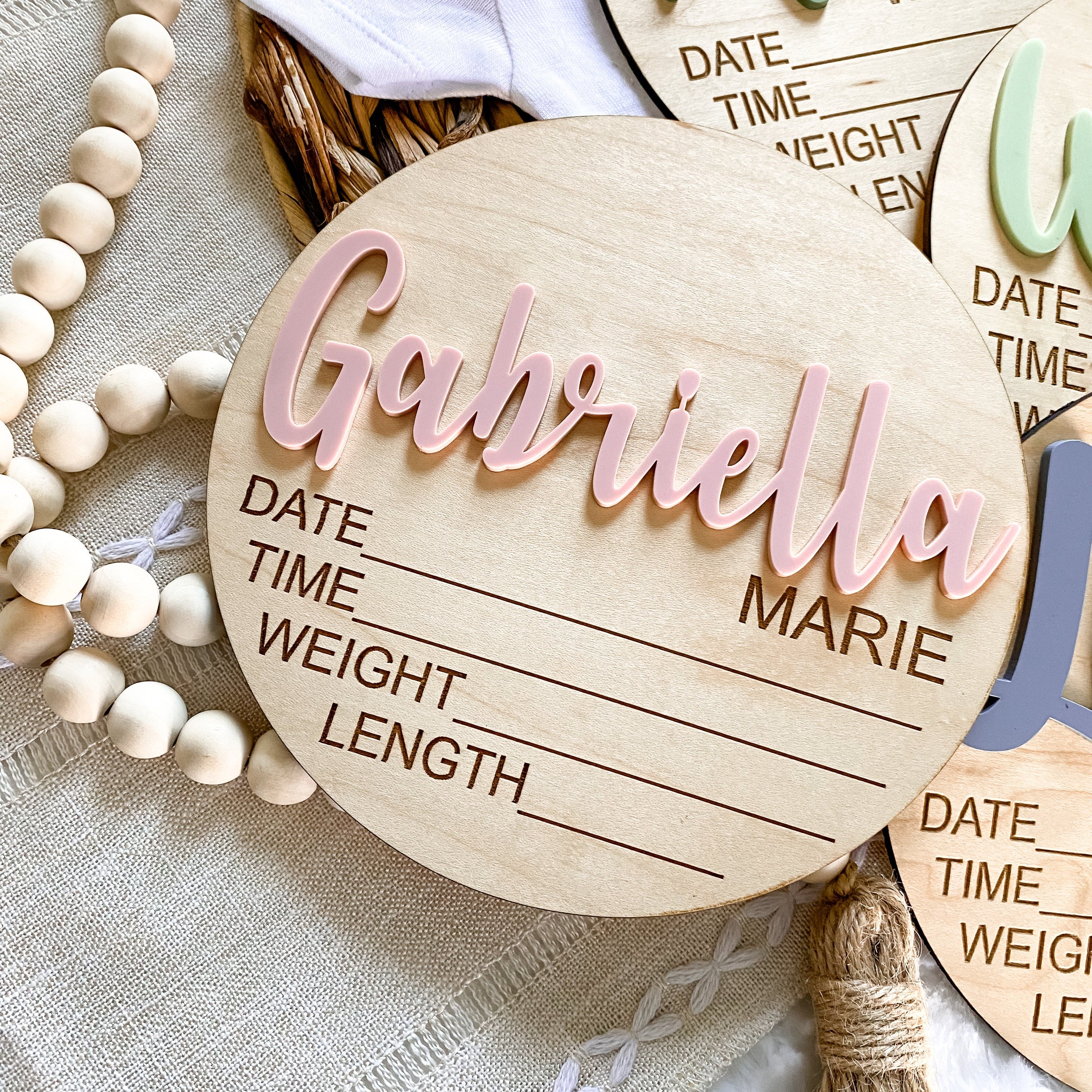Personalized wooden baby birth announcement sign with name Gabriella Marie, for nursery decor and newborn keepsakes.