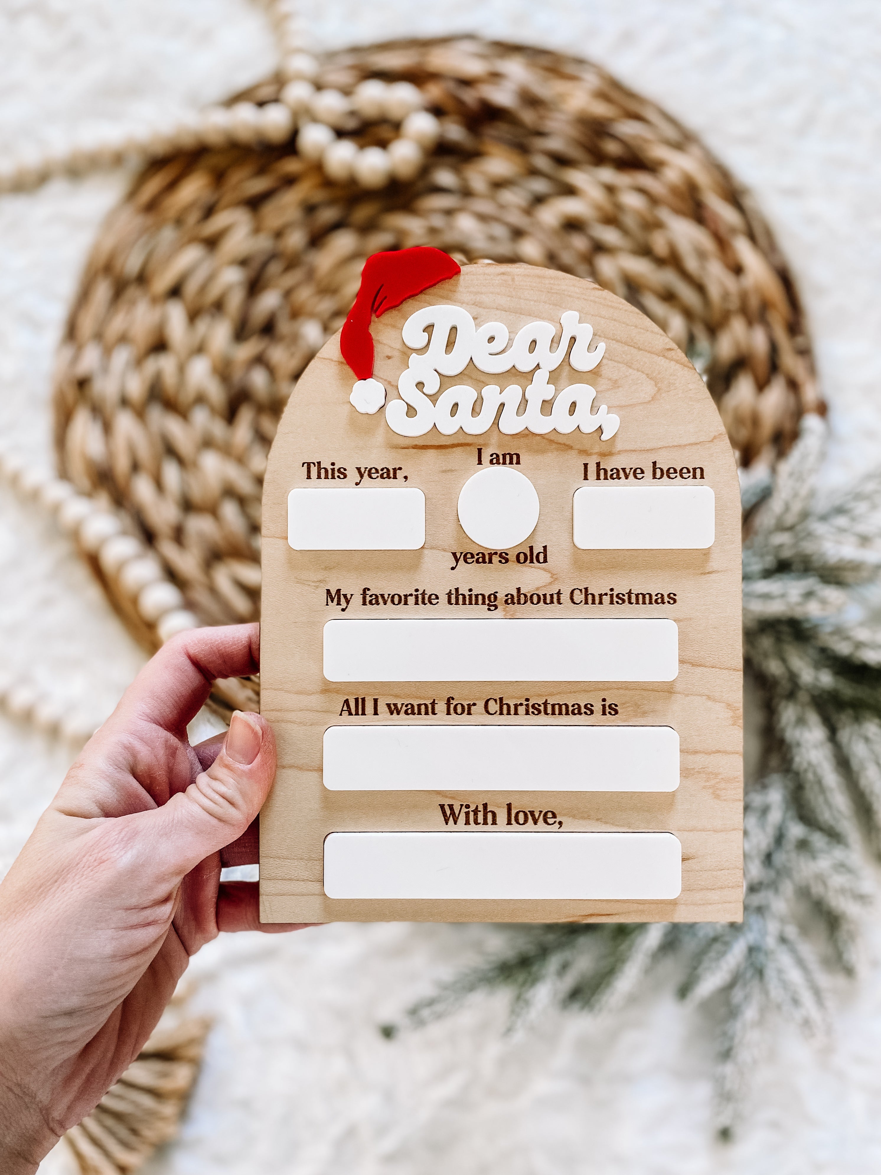 Wooden 'Dear Santa' letter template with fill-in blanks for kids' Christmas wishes and festive red hat accent.