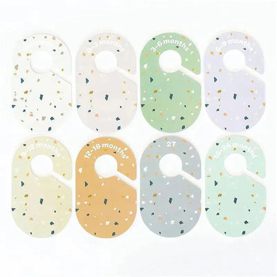 Colorful closet dividers labeled for baby clothing sizes: 0-3 months, 3-6 months, 6-9 months, 12-18 months, 2T, and 18-24 months.