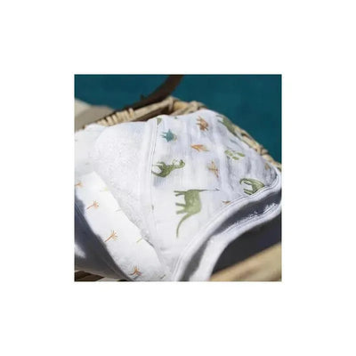 Hooded baby bath towels featuring dinosaur designs in green and orange, stacked in a wicker basket.