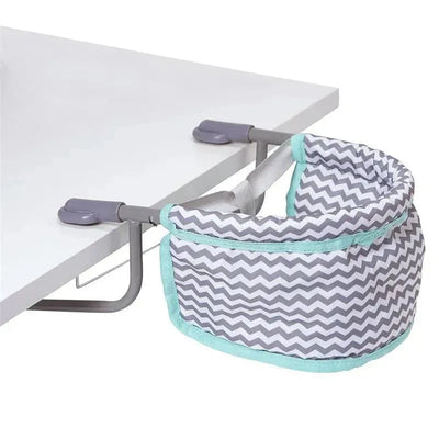 Zigzag-patterned Adora feeding seat securely attached to a table with gray and mint green accents.