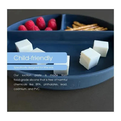 Baby plate in pink silicone features divided portions, suction base, and includes food items like cheese cubes, raspberries, and pretzels.