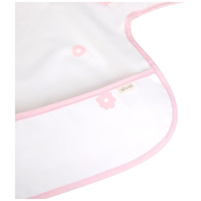 Long sleeve smock bib in pink with floral patterns, featuring a stitched label from Ali + Oli.