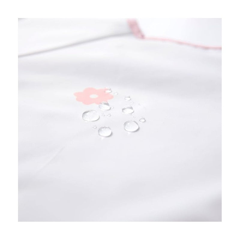 Long sleeve smock bib in white with pink flower design and water droplets, showcasing its waterproof feature.