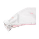 Long sleeve smock bib in white with pink flower patterns and elastic cuffs, designed for protecting clothing during meals.