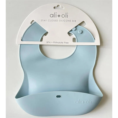 Ali+Oli silicone baby bib in sky blue, designed to roll up and stay closed, BPA and phthalate free.