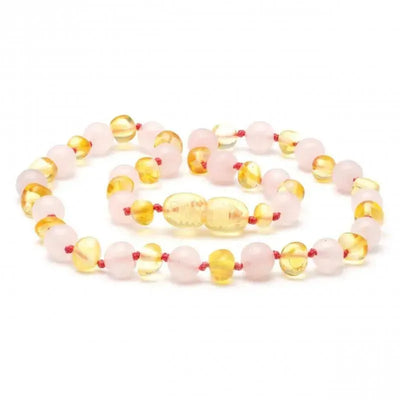 Baltic amber and rose quartz necklace featuring yellow and pink beads, strung on red thread.