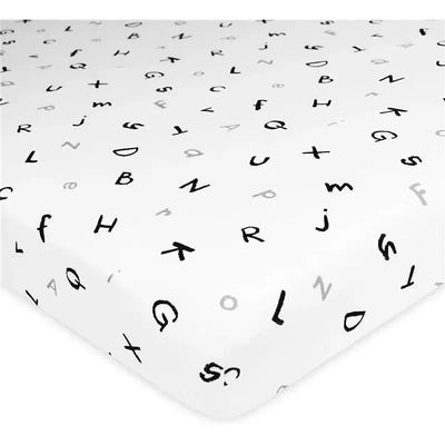 Fitted bassinet sheet made of 100% natural cotton jersey knit, featuring a playful alphabet print in black and grey on a white background.