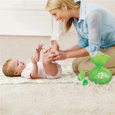 A smiling woman plays with a baby on a changing pad, with green Arm & Hammer bag refills visible nearby.