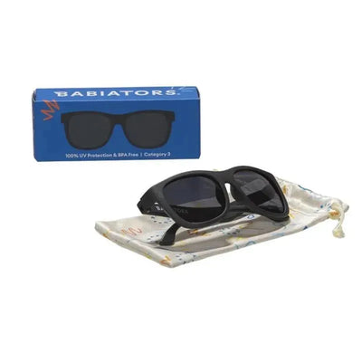 Babiators Original Navigator Baby Sunglasses in Jet Black with packaging and a soft pouch for storage.