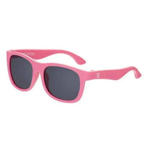 Original Navigator baby sunglasses by Babiators in a vibrant pink color with dark lenses.
