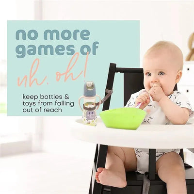 Baby Buddy Secure A Toy Tether in black/white on a high chair, with a baby eating and a bottle secured to the chair.