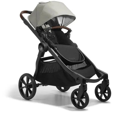 Single to double stroller by Baby Jogger in Frosted Ivory, featuring a black seat and a sun canopy.