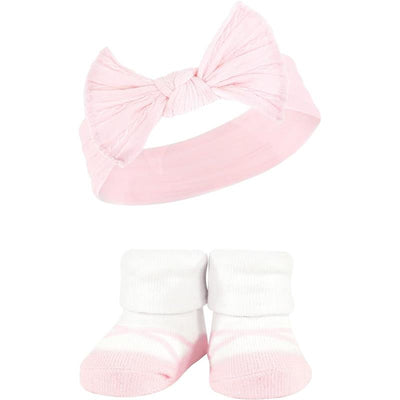 Knit headband with a large bow in pink and a matching pair of soft socks with a pink and white design.
