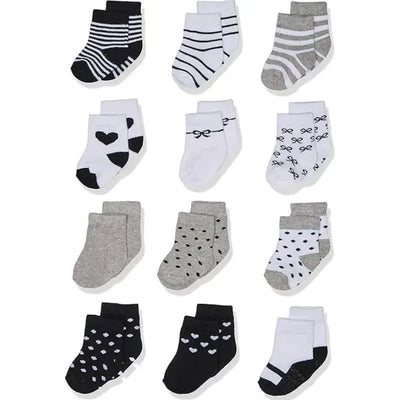Twelve pairs of baby girl socks in gray, black, and white designs, featuring stripes, hearts, and polka dots.