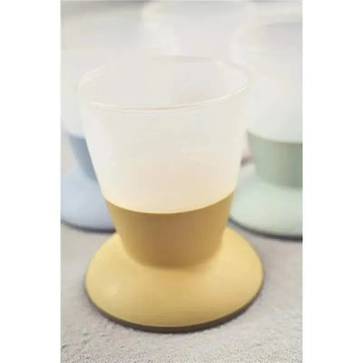 Two Babybjorn baby cups in powder green, featuring a stable base and a soft color, designed for easy handling.
