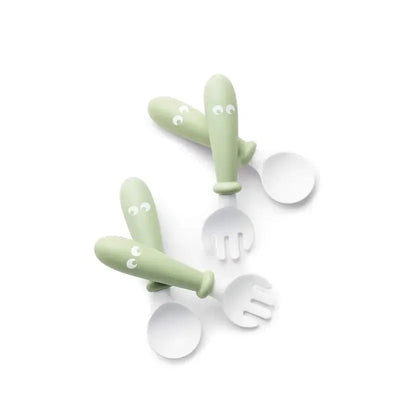 BabyBjorn Baby Spoon and Fork set in Powder Green, featuring four pieces with playful designs and easy-to-handle grips.