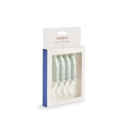 BabyBjorn Baby Spoon and Fork set, four pieces in powder green, packaged with a clear front.