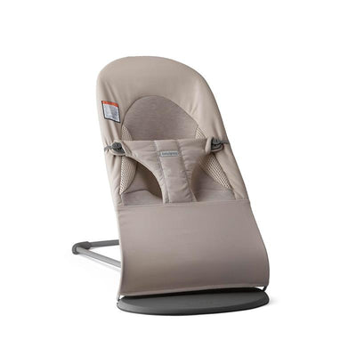 Bouncer Balance Soft Tri-Fabric in Sand Gray, featuring a soft seat with safety harness and curved base for rocking.