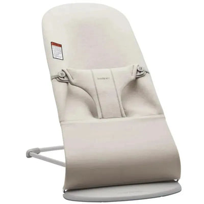 Light beige BabyBjorn Bouncer Bliss with a soft fabric seat, adjustable harness, and a sturdy base for infants.