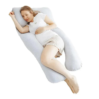 Pregnant woman resting comfortably on a grey Babymoov XXL B.Love maternity body pillow.