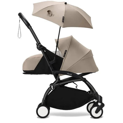 Babyzen YOYO stroller in taupe with a matching adjustable parasol, featuring a compact design and black frame.
