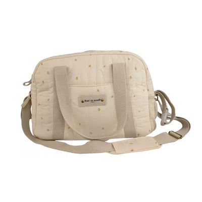 Cream-colored Bbluv Simply Diaper Bag made of cotton, featuring a quilted design and adjustable strap.