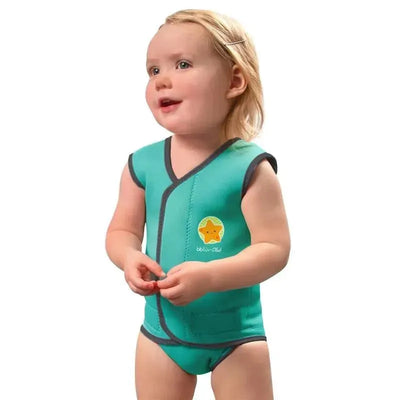 A toddler wearing an aqua Bbluv Wrap neoprene baby wetsuit, smiling and playing, with a star logo visible on the suit.