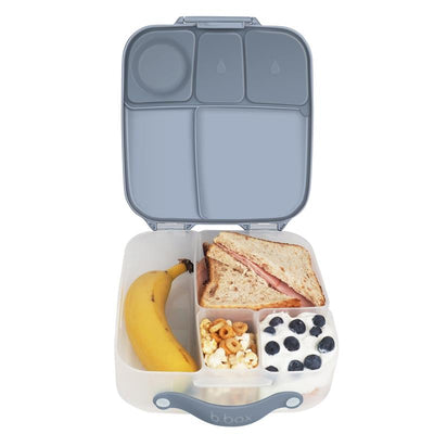 Oversized BBox lunch box for kids, featuring compartments with a sandwich, banana, popcorn, yogurt with blueberries, and a sleek design.