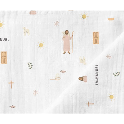 Muslin swaddle blanket featuring illustrations of Jesus, sheep, sun, and various symbols in soft colors.