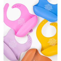 Silicone bibs in various colors including sage green, featuring blessing text for mealtime.