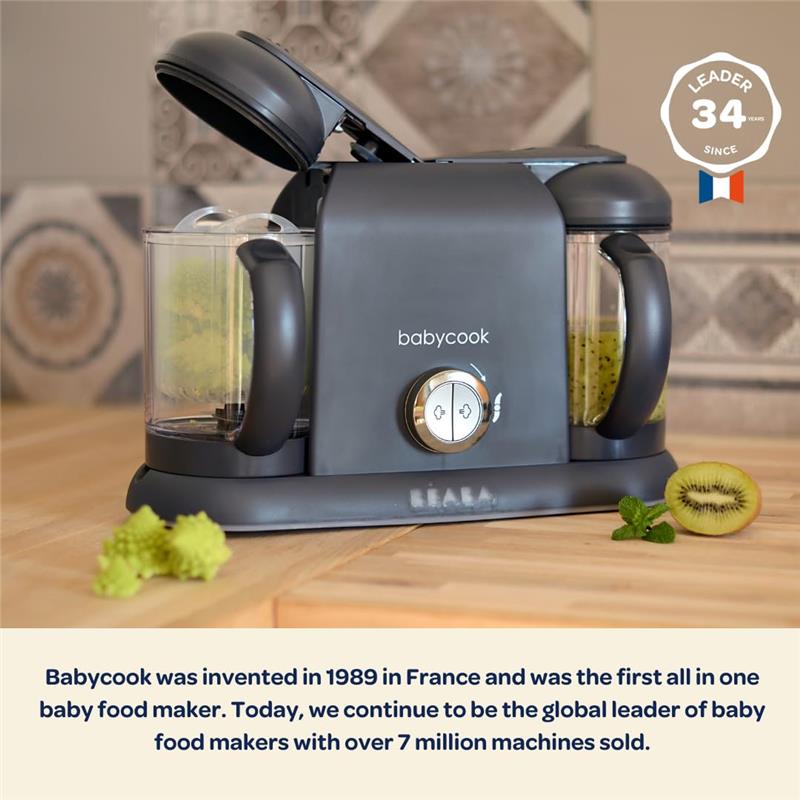 Beaba Babycook Duo 4 in 1 Baby Food Maker in Midnight color, featuring a clear bowl, blending knob, and kiwi slices.