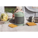 Stainless steel insulated food jar by Beaba in sage color, surrounded by snacks and fruit.