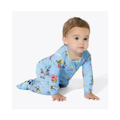 Bamboo footie sleeper for infants featuring colorful Spongebob Squarepants characters, worn by a crawling baby.