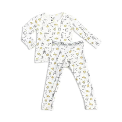 Bamboo pajamas for kids featuring a milk and cookies print, including a long-sleeve shirt and matching leggings.