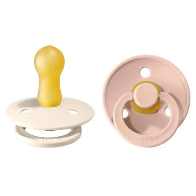 Natural rubber baby pacifiers in blush and ivory colors, designed for ages 6 to 18 months.