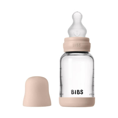4 oz Bibs silicone baby bottle in blush color with a clear glass body and a matching cap.