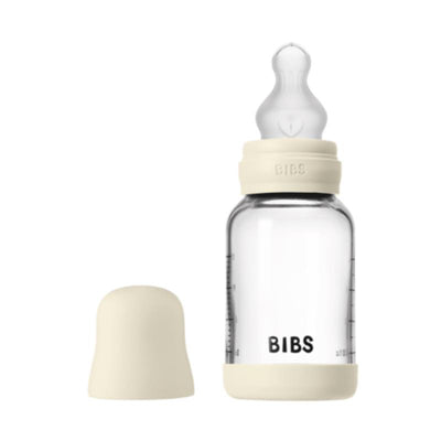4oz silicone baby bottle from Bibs in ivory color, featuring a translucent glass body and a removable cap.