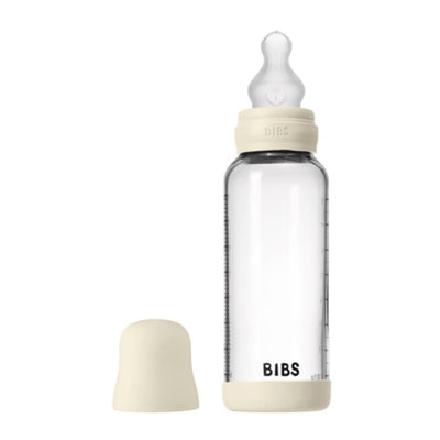 8oz silicone baby bottle in ivory with a transparent glass body and removable silicone bumper.