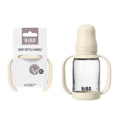 Baby bottle handle in ivory color displayed alongside its packaging, compatible with Bibs baby bottles for infants aged 6 months and up.