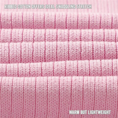 Ribbed pink cotton baby swaddle blanket, highlighting its softness and lightweight characteristics.